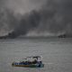 Fotografía de dos embarcación incendiándose este 6 de junio de 2026, en el puerto de Manta (Ecuador). EFE/ Ariel Ochoa