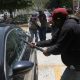 Una persona vandaliza un vehículo este martes, durante una protesta de integrantes de la Coordinadora Nacional de Trabajadores de la Educación (CNTE), en Chilpancingo (México). EFE/ José Luis De La Cruz
