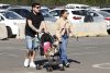 Fotografía tomada el pasado 30 de mayo en la que se captó a una pareja al caminar con un par de perros, llevados en un choche de bebés, durante la feria 'Expo Mascotas & Animales', en Santiago de Chile. EFE/Elvis González
