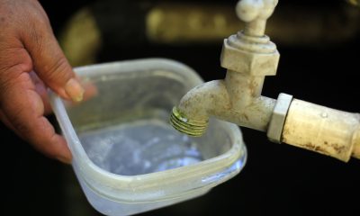 Fotografía de archivo de una persona intenta llenar un recipiente con agua. EFE/ Gustavo Amador